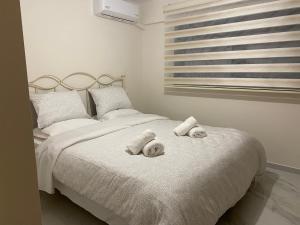 a bedroom with a bed with towels on it at Finix Loft Trikala in Tríkala