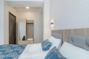 Uma cama ou camas num quarto em Vita Gardenia Hotel Tskaltubo