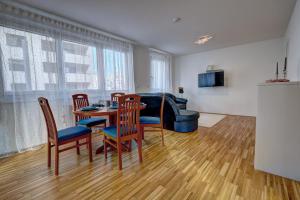 a living room with a table and chairs and a couch at Carin Deluxe I in Vienna