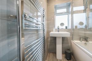 een badkamer met een wastafel, een toilet en een douche bij Wolviston House By Horizon Stays in Stockton-on-Tees