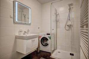 a bathroom with a washing machine and a washer at Carin Deluxe I in Vienna +30 photos