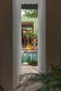 a view of a pool from a building with a person in the background at Hostik Hostal in Mérida