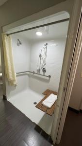 a bathroom with a tub with a towel in it at America's Best Value Inn and Suites - Jackson in Jackson