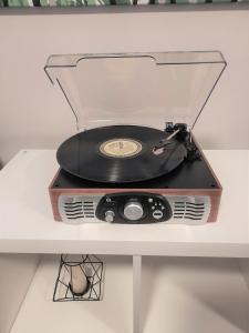 a record player sitting on a white table at Chic Studio Minutes to DT in Calgary