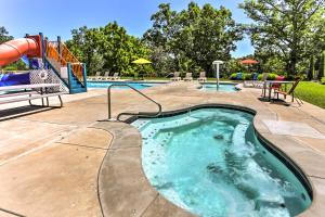 a swimming pool with a slide and a playground at Branson Home with Game Room, Near Silver Dollar City in Branson