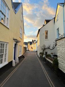 an empty street in a town with houses at Church View a first floor apartment in the heart of historic Topsham in Topsham