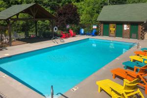 a swimming pool with chairs and a gazebo at Inviting Sevierville Cabin with Deck and Hot Tub! in Sevierville