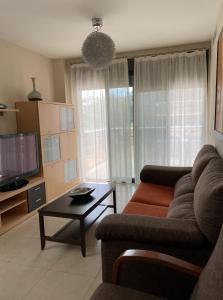 a living room with a couch and a table at Residencial Los Flamencos in Benicàssim