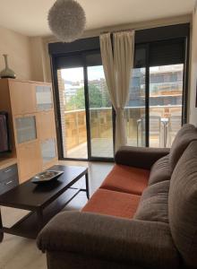 a living room with a couch and a table at Residencial Los Flamencos in Benicàssim