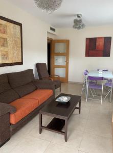 a living room with a couch and a table at Residencial Los Flamencos in Benicàssim +36 photos