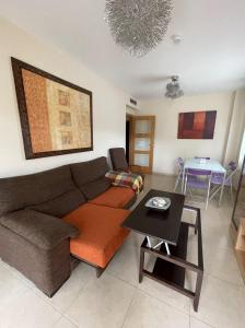 a living room with a couch and a table at Residencial Los Flamencos in Benicàssim