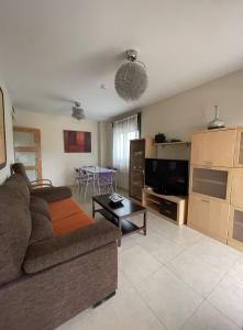 a living room with a couch and a table at Residencial Los Flamencos in Benicàssim