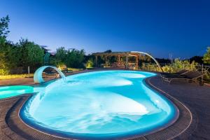 a large swimming pool with a water slide at Affittacamere S'Alzola in Porto Rotondo