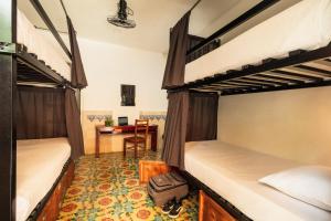 Letto o letti in una camera di Che Nomadas Mérida Hostel Adults Only