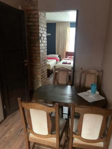 a dining room with a table and chairs and a mirror at Delta 8 - two big beds in Tartu