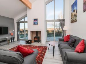 a living room with two couches and a fireplace at Clover Cottage in Newcastle upon Tyne