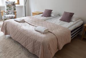 a bedroom with two beds with towels on them at 2ndhomes Luxurious 144 m2 Stylish 3 Bedroom Center Apartment in Helsinki