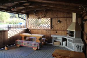 a wooden cabin with a stove and a table at U Belianky in Terchová