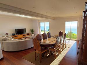 a living room with a table and a couch at Neves by BCA Villas in São Gonçalo