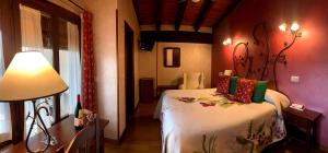 Postel nebo postele na pokoji v ubytování Hotel Doña Sancha