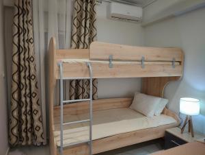 a bunk bed in a room with a lamp at Cozy Sea View Apartment in Paralia in Paralia Katerinis