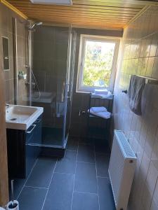 a small bathroom with a sink and a shower at Ferienwohnung Siegen Eiserfeld 2 in Siegen