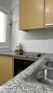 a kitchen with a sink and a counter top at The Appartment in Llança