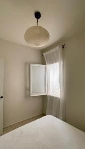 a bedroom with a window with a white curtain at The Appartment in Llança