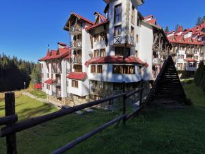 a building with a fence in front of it at Ski Area @ Apartment Rosea 205 @ Pamporovo in Pamporovo