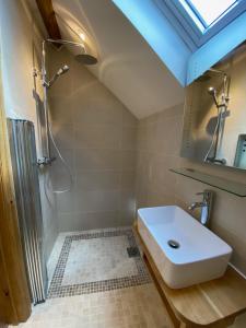 a bathroom with a sink and a shower at Folly Cottage & The Old Forge in Colerne