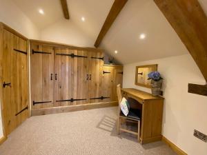 a large room with wooden lockers in a house at Folly Cottage & The Old Forge in Colerne