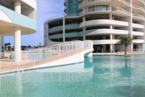 a swimming pool in front of a building at Turquoise D1306 in Orange Beach