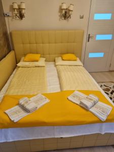 Dos camas en una habitación con toallas. en La Tanti Bobi, en Lupeni