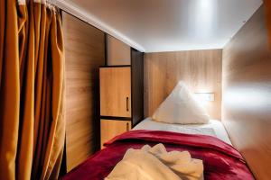 Habitación pequeña con cama y cortina en Hostel Westlight en Hamburgo