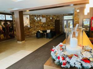 a lobby with a vase with a candle on a table at Apartmány KAMZÍK Donovaly in Donovaly