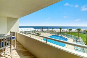 a balcony with a view of a pool and the ocean at Perdido Sun 212 in Perdido Key