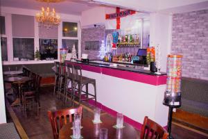 a bar in a restaurant with tables and chairs at MyRoomz Hollingdales Hotel in Blackpool +40 photos