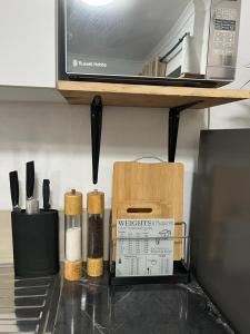 a kitchen counter with spices and a microwave at Orange Leaf Unit 1 in Durban