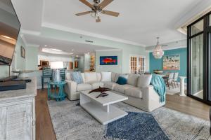 a living room with a couch and a table at Phoenix West 1508 in Orange Beach