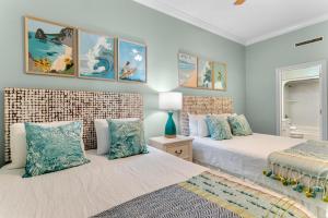 two beds in a bedroom with blue walls at Phoenix West 1508 in Orange Beach +28 photos