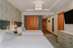 a hotel room with two beds and a bathroom at Summit Hotel at Big Sky Resort in Big Sky