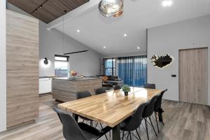 a kitchen and dining room with a wooden table and chairs at The Lava Bowl in Grindavík +25 photos