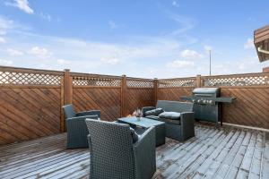 a patio with chairs and a table on a deck at The Lava Bowl in Grindavík