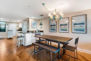 a kitchen and dining room with a wooden table and chairs at Perdido Towers East 104 in Perdido Key