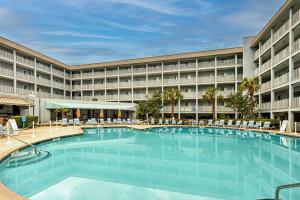a large swimming pool in front of a hotel at Hilton Head Resort Condo with Beach and Pool Access! in Hilton Head Island