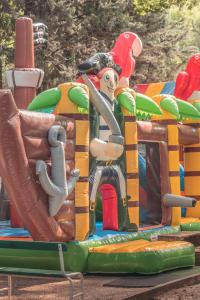 a play structure with a clown on a playground at Camping la Peiriere - Chalet & Mobile-home in Tuchan