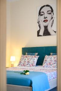 een slaapkamer met een bed met een schilderij aan de muur bij Apartment CALLAS in Corfu Town in Corfu-stad