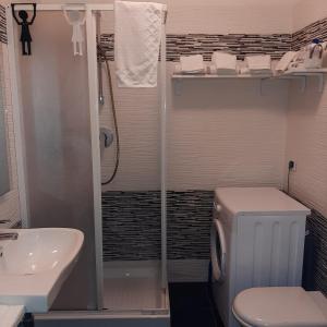 a bathroom with a shower and a toilet and a sink at la passeggiata in Lido di Ostia