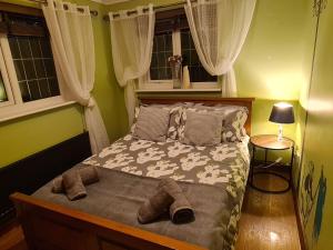 a bedroom with a bed with slippers on it at Spacious, 5 bed house for 9 in Chester in Chester
