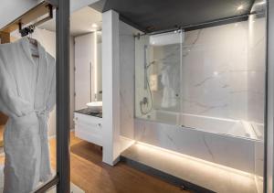 a bathroom with a walk in shower and a sink at 987 Design Prague Hotel in Prague